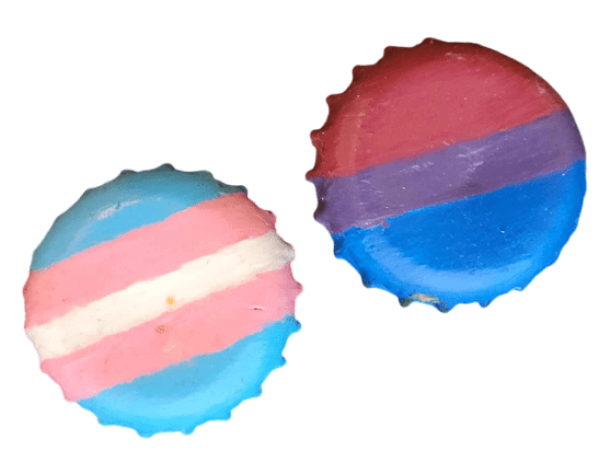 Two bottle cap pins, one with the trans flag and one with the bisexual flag.